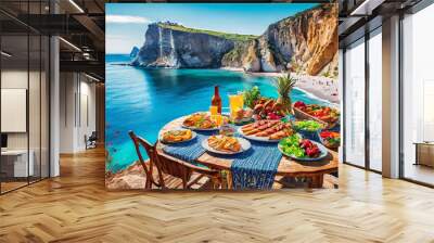 a table with a lot of food on it near the water and a cliff side with a blue ocean in the background and a blue sky Wall mural