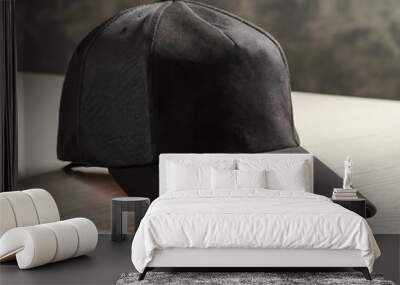 Black cap on table against white background. Mockup for design Wall mural