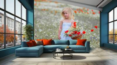 child in a flower field in spring Wall mural