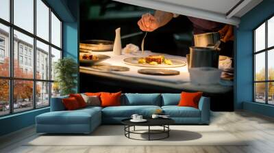 Chef preparing a dish with meat on a plate under a light. The chef is meticulous.  Wall mural