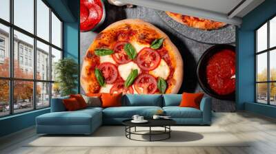 Homemade margherita and pepperoni pizza with fresh basil and garlic on a dark background Wall mural