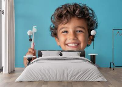 Portrait of a Happy Smiling Boy Holding a Toothbrush on a Blue Background, Close-Up Studio Shot of a Cute Kid with a Teeth Cleaning Product, Highlighting Dental Hygiene in Commercial Photography Style Wall mural