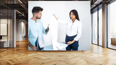 young couple asian European speaking about ironing Wall mural