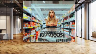 Confused Client Thinking What to Buy in a Supermarket. Buyer deciding about purchases in a big store 
 Wall mural