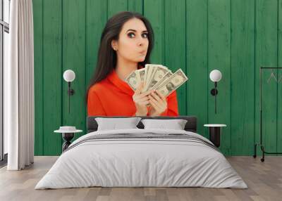 Funny Casual Girl Holding Money Thinking to Invest Wall mural