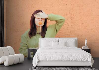 Funny Girlfriend Covering her Eyes Holding a Party Accessory Wall mural