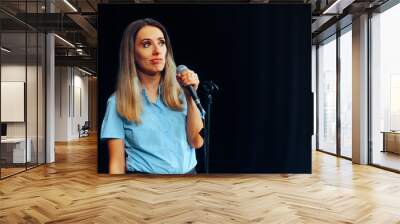 Puzzled Woman Having Problems Talking in Public. Nervous presenter staring conference with her speech 

 Wall mural