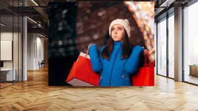 Tired Girl Holding Shopping Bags on Christmas Lights Décor Wall mural