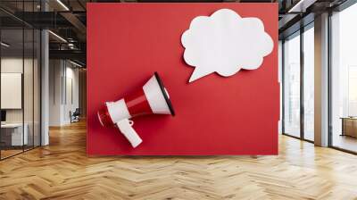 Red background with white speech bubble, red megaphone pointing diagonally toward left Wall mural