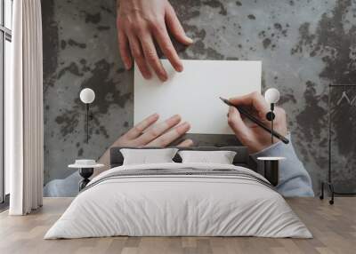 Two Adult Hands Hold Pencil, Poised to Write on White Paper Wall mural