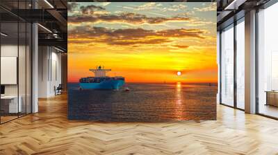 Container ship on sea road during sunrise. Wall mural