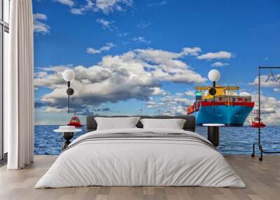 Tugboat assisting container cargo ship to harbor. Wall mural