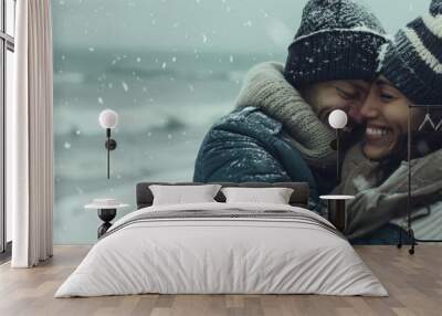 A happy couple cuddling on a beach in the winter Wall mural