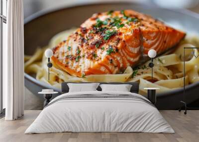 a pasta dish topped with a salmon slice. Herbs and spices are used to season the salmon. After being cooked, the pasta is served in a bowl. The dish appears tasty and appealing. Wall mural