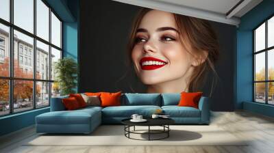 Close-up of a charming, attractive young woman grinning and wearing red lipstick against a dark grey background. cosmetics and makeup artistry. Idea of magazine, emotions, beauty, fashion, and adverti Wall mural