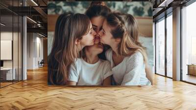 Female family members cuddled up on a bed inside a house, giving and receiving hugs and kisses as they showered in affection between their mother and daughters. kin across generations, sentiments and  Wall mural