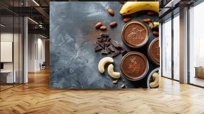 Homemade chocolate banana nut smoothies with ingredients for making over light grey slate, stone or concrete background.Top view with copy space Wall mural