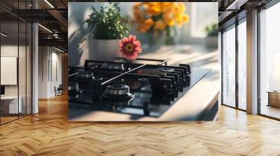 This modern gas hob stove with tempered black glass cooks food on natural gas or propane and is placed on a light countertop in the interior kitchen with flowers and an oven tea pot. Wall mural