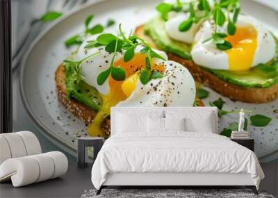 Two slices of toast with avocado and egg on top Wall mural