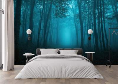 A forest with a blue sky in the background Wall mural