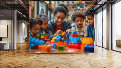 A group of children are playing with legos, with a woman watching over them Wall mural