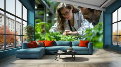 Two people are looking at plants in a greenhouse Wall mural