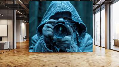 Hooded Figure Holding a Camera in a Gloomy Setting Wall mural