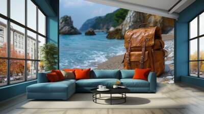 Leather Backpack Resting on a Pebble Beach by the Ocean Wall mural