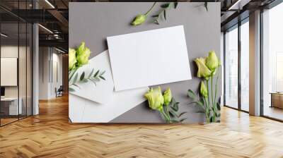 Blank wedding invitation card mockup with eustoma flowers and white envelope on grey Wall mural