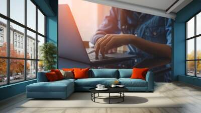 Casual business woman hands holding electronic or stylus pencil and typing on laptop computer keyboard with black digital tablet on the desk at office. Online working concept. Flare light. Wall mural