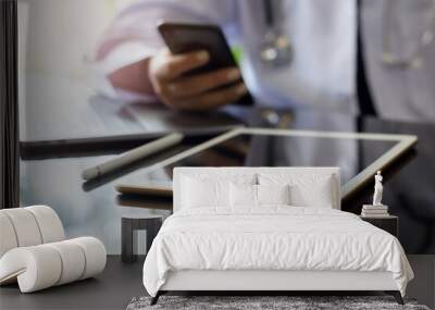 Doctor using phone and work on digital tablet. Wall mural