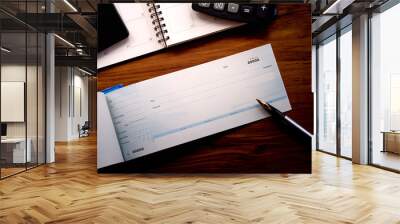 Mock up image of cheque book,mobile phone,weekly planner and calculator isolated on wooden table background. Wall mural