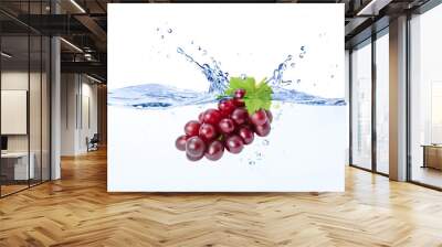 Red grapes falling in blue clear wave water splash isolated on white background. Wall mural