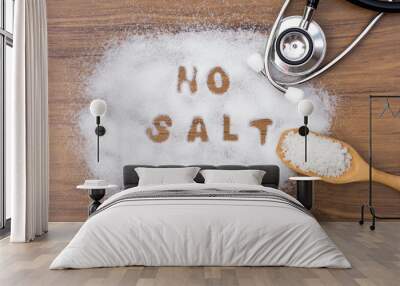 White granulated natural sea salt in wooden scoop and words