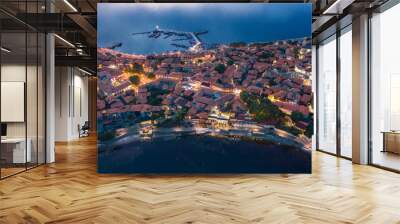 Aerial view to a sea town at night Wall mural