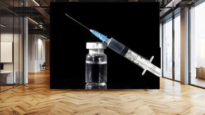 Glass Medicine Vials and Syringe on black background Wall mural