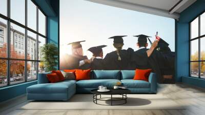 Group, students and graduation for college or university friends together with blue sky mockup. Men and women outdoor to celebrate education achievement, success and future at event for graduates Wall mural