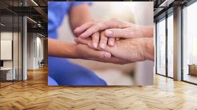 Im here to help. Cropped shot of a nurse holding a senior womans hands in comfort. Wall mural