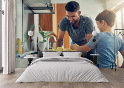 The super disinfecting son and dad duo. Shot of a father and son cleaning the kitchen counter together at home. Wall mural