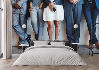 Waiting to role with the best. Shot of a group of unrecognizable businesspeople waiting in line for their interviews inside of a office during the day. Wall mural