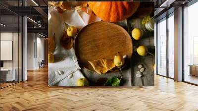 There is a layout of pumpkin and autumn leaves on the kitchen table  Wall mural