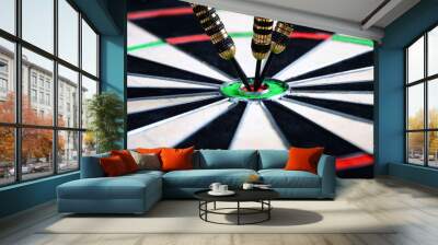 Dart arrow hitting in the target center of dartboard. Wall mural