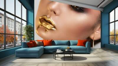 Portrait of girl with the distinctly painted eyes by a shining skin by well-groomed eyebrows and liquid gold on lips Wall mural