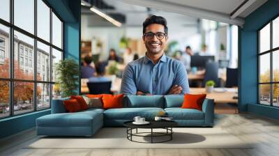 Smiling Indian Businessman Standing With His Arms Crossed in a Modern IT Company Office Wall mural