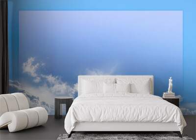 Bright sunny blue sky border frame background - clouds along bottom edge with a blue sky above and a graduated lighter central area ideal as an announcement back drop
 Wall mural