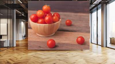 Group tomato in a wood bowl place on the wooden table Wall mural