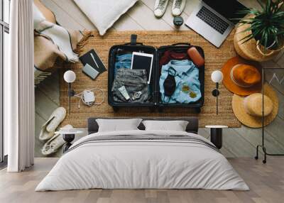 Packing suitcase for travel vacation in new normal, top view. Wall mural