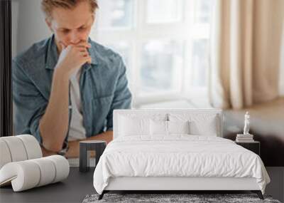 Upset caucasian man communicating with his psychologist, at a psychotherapy session to maintain internal health. Wall mural