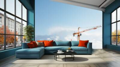 building cranes at the construction site on blue sky background Wall mural