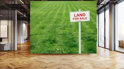 land for sale sign against trimmed lawn background Wall mural